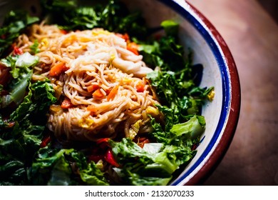 A Large Bowl Of Asian Noodles And Fresh Salad.