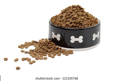 A Large Bowl Of Dog Food Spilling Onto A White Background.