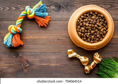 Large Bowl Of Pet - Dog Food With Toys On Wooden Background Top View Mockup