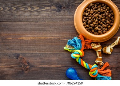 Large Bowl Of Pet - Dog Food With Toys On Wooden Background Top View Mockup