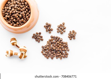 Large Bowl Of Pet - Dog Food Spilling In Paw Print On White Background Top View Mockup