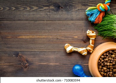 Large Bowl Of Pet - Dog Food With Toys On Wooden Background Top View Mockup