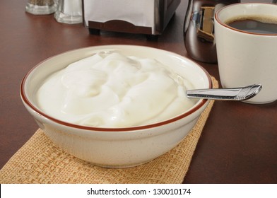 A Large Bowl Of Plain Or Vanilla Yogurt With Coffee