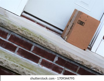 Large Box On Front Door Steps Of Residential House