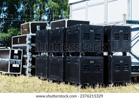 Large boxes for storing and transporting concert equipment. Preparing for a mass outdoor event. Close-up