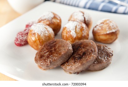 Large Breakfast Of Sausage Patties, Baked Delicious Danish Pancakes And Raspberries