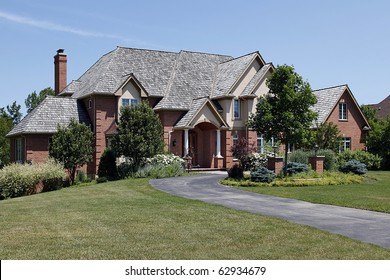 Large Brick Home With Cedar Shake Roof