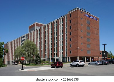 Large Brick Hospital Style Building With Parking Lot