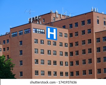 Large Brick Hospital Type Building With Block Letter H Sign