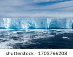 Large bright blue iceburg floating in Antarctica.