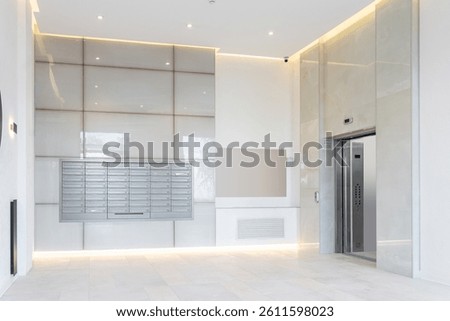 a large, bright lobby with an elevator in an elite multi-storey building or hotel