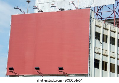 A Large Brown Billboard Is Attached To The Side Of The Building.