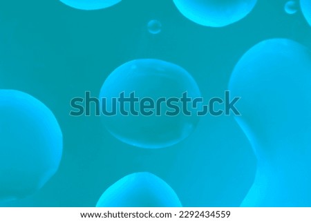 large bubble like a lava lamp break through thick liquid creating orbs which glow