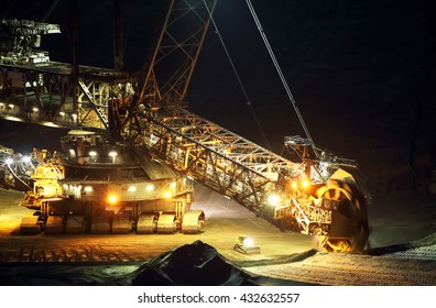 A large bucket wheel excavator in a lignite (brown-coal) mine at night, Germany