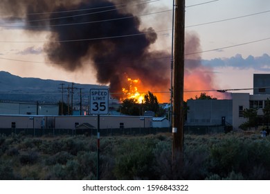 Large Building Fire With Smoke Cloud And Flames In The Distance