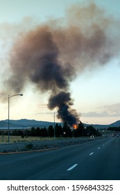 Large Building Fire With Smoke Cloud In The Distance Down The Street