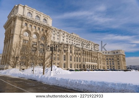 Large building of the Palace of the Parliament also known as People's House (Casa Poporului) in Constitutiei Square (Piata Constitutiei) in Bucharest, Romania, East Europe, in snowy winter scenery Stock photo © 