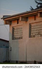A large building that features numerous windows and has a distinct roof structure, designed to allow for adequate natural light inside