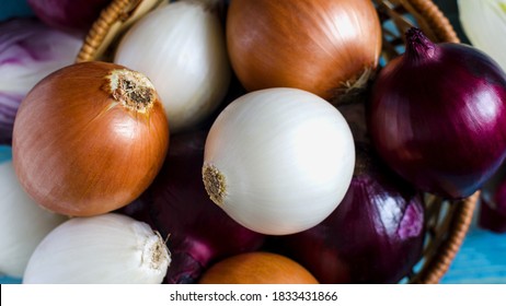 large bulbs of yellow, red and white onions close-up in a wicker basket	 - Powered by Shutterstock