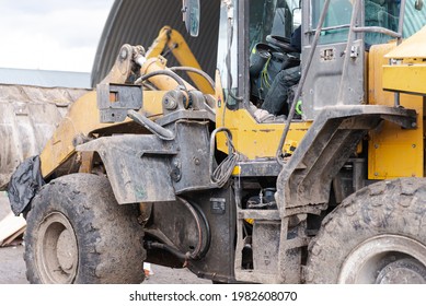 Large Bulldozer Rear And Left. Dirty Yellow Bulldozer Close-up With Open Cab.