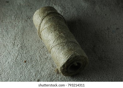 A Large Bundle Of Twine Lies On The Carpet.