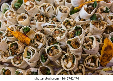 Large Burrito Platter. Half Size Burritos Wrapped And Served At A Party. Top View, Close-up Photo.