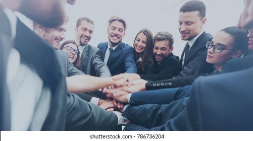 Large business team showing unity with their hands together - Shutterstock ID 786736204
