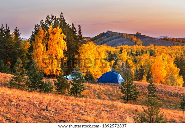 a large camping tent stands
against the backdrop of the Ural ridge Nurali.
Bashkortostan.