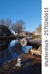 large cannon on the edge of a canal in the Dutch city of Leiden