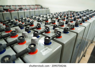 Large capacity batteries in a modern power plant building. Group of green energy accumulators.