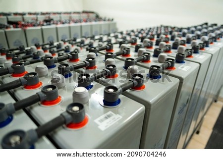 Large capacity batteries in a modern power plant building. Group of green energy accumulators.