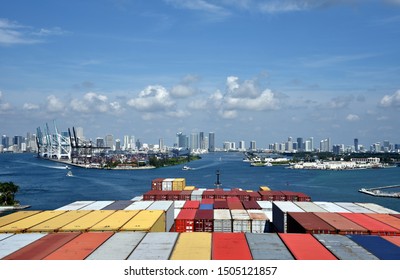 Large cargo container ship arriving to the port of Miami, Florida. View from the navigational bridge on the container terminal and Miami skyline. 