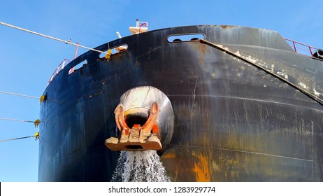 Large Cargo Ship Discharging Ballast Water Out From The Anchor's Hub