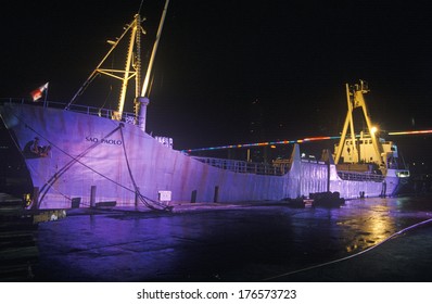 A Large Cargo Ship, The Sao Paolo, Lit Up At Night In A Miami, Florida Harbor