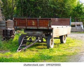 A Large Cargo Trailer On Wheels Stands In The Backyard On A Sunny Summer Day