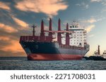 large carrier ship floating  afternoon in sea, tugboat dragging container ship, blue sky evening background and sea front, mode of transportation concept,