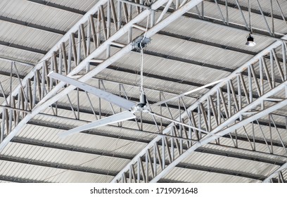 Large Ceiling Fan On The Metal Frame Of The Warehouse For Ventilation.