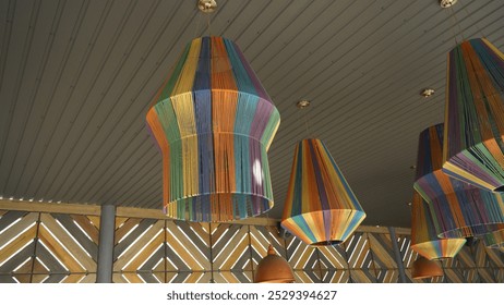 Large chandelier with a metal shade decorated with colored threads, lamp, lamp, chandelier, decorative element, lighting, interior lighting - Powered by Shutterstock