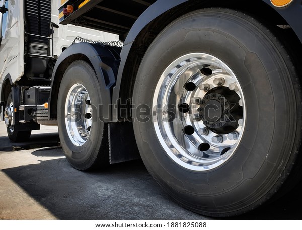 Large chromed truck wheel and big tires.\
Semi truck transport industry. Road freight. \
