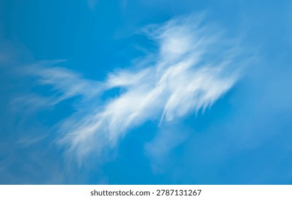 A large cirrus cloud. Clouds flowing lazily like cottony fibers against a clear, serene blue background. The sky speaks of calm, peace, and silence.