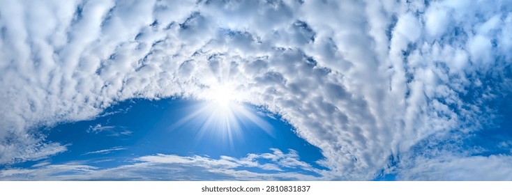 A large cirrus cloud. Clouds flowing lazily like cottony fibers against a clear, serene blue background. The sky speaks of calm, peace, and silence.
