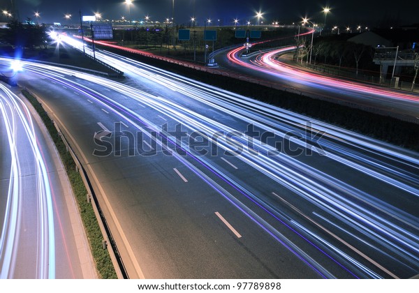 Large city road night scene, night car rainbow\
light trails