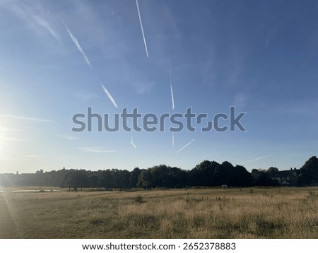 large cloudless sky with whisps of plane fumes