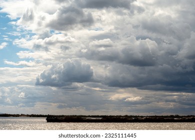 large clouds of different shapes against a blue sky background