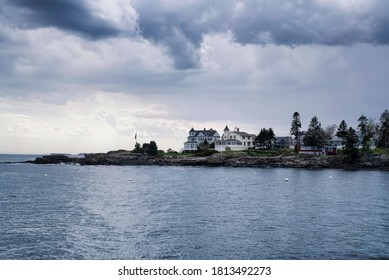 large coastal maine homes on Johns Bay in Bristol Maine under a stormy dramatic sky.  
