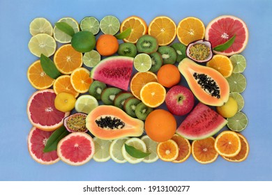 Large collection of high fibre fruit very high in antioxidants, anthocyanins, lycopene and  vitamin c. Immune boosting health care concept. Flat lay top view with border on mottled blue background.