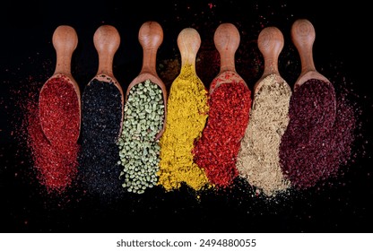 Large collection of spices and herbs in wooden spoons. Seasonings for food isolated on a black background. Colourful various herbs and spices for cooking. Herbs and spices on graphite background. - Powered by Shutterstock