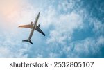  A large commercial airplane soars through a clear blue sky with fluffy white clouds.