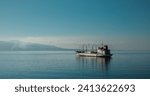 Large commercial fishing vessel in the sea. Big fishing ship in the sea in the coast of Albania. Fishing boat at sea,