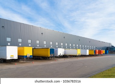 large commercial warehouse with trailers in front